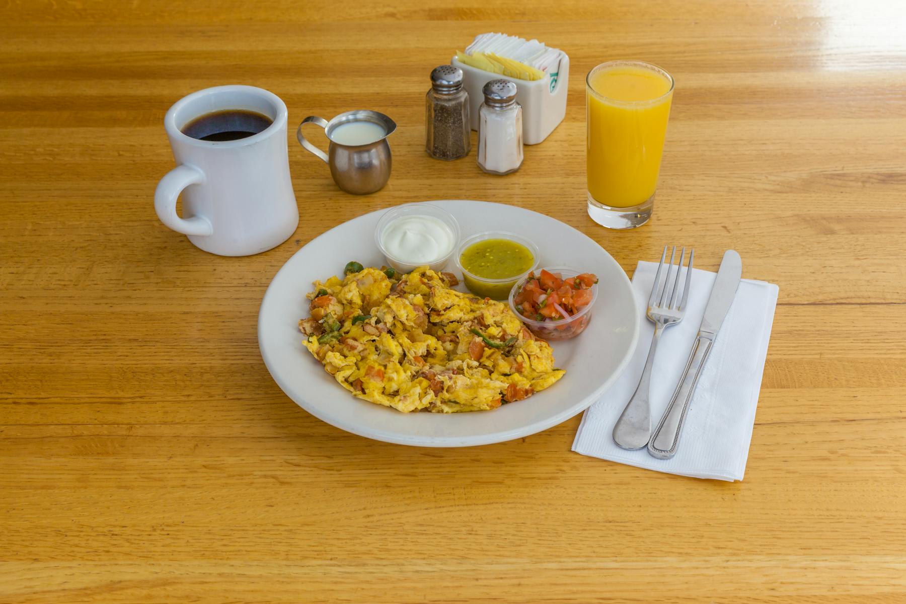 omelet with sauces on the side with coffee and juice